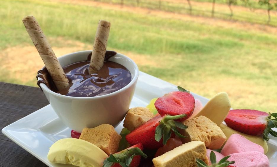 dipping chocolcate and fresh fruit on a sample plate